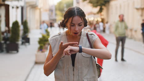 young woman worrying to be punctual, with anxiety checking time on watch, running late to work