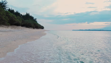 Lonely-woman-sitting-on-tropical-paradise-sand-beach-and-looking-to-the-sea