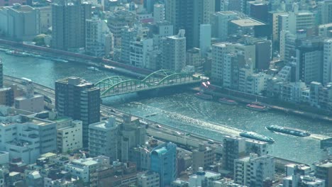 aerial view of tokyo river and ferry crossing under the bridge from skytree tower