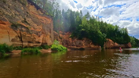 gauja national park river with sandy cliffs on sunny day