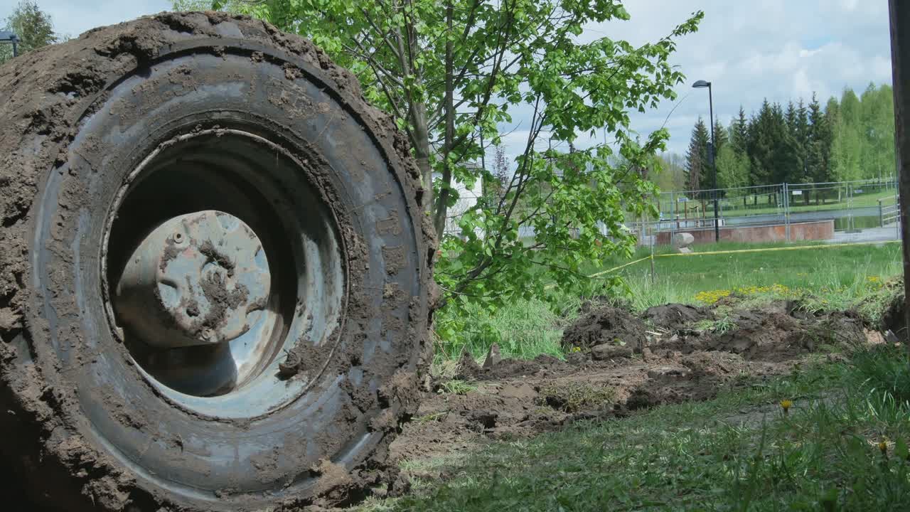 Excavator With Bucket Levels the Road Base Surface on a Construction Site