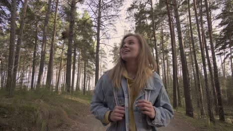 young smiling girl walking in the autumn forest