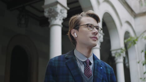 student putting on wireless earphones