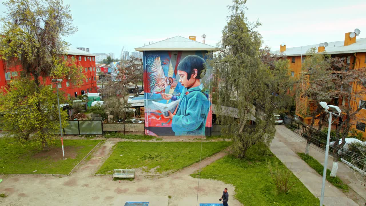 Static aerial view of a mural Gorrion in the open air museum of San Miguel in Santiago de Chile, the neighborhood that has been revived by art.
