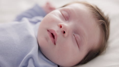 face, relax and sleep with a baby on a bed closeup