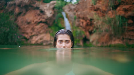 attractive woman diving lagoon posing alone portrait. seductive lady swimming