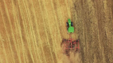 aerial view of tractor and cultivator working a field