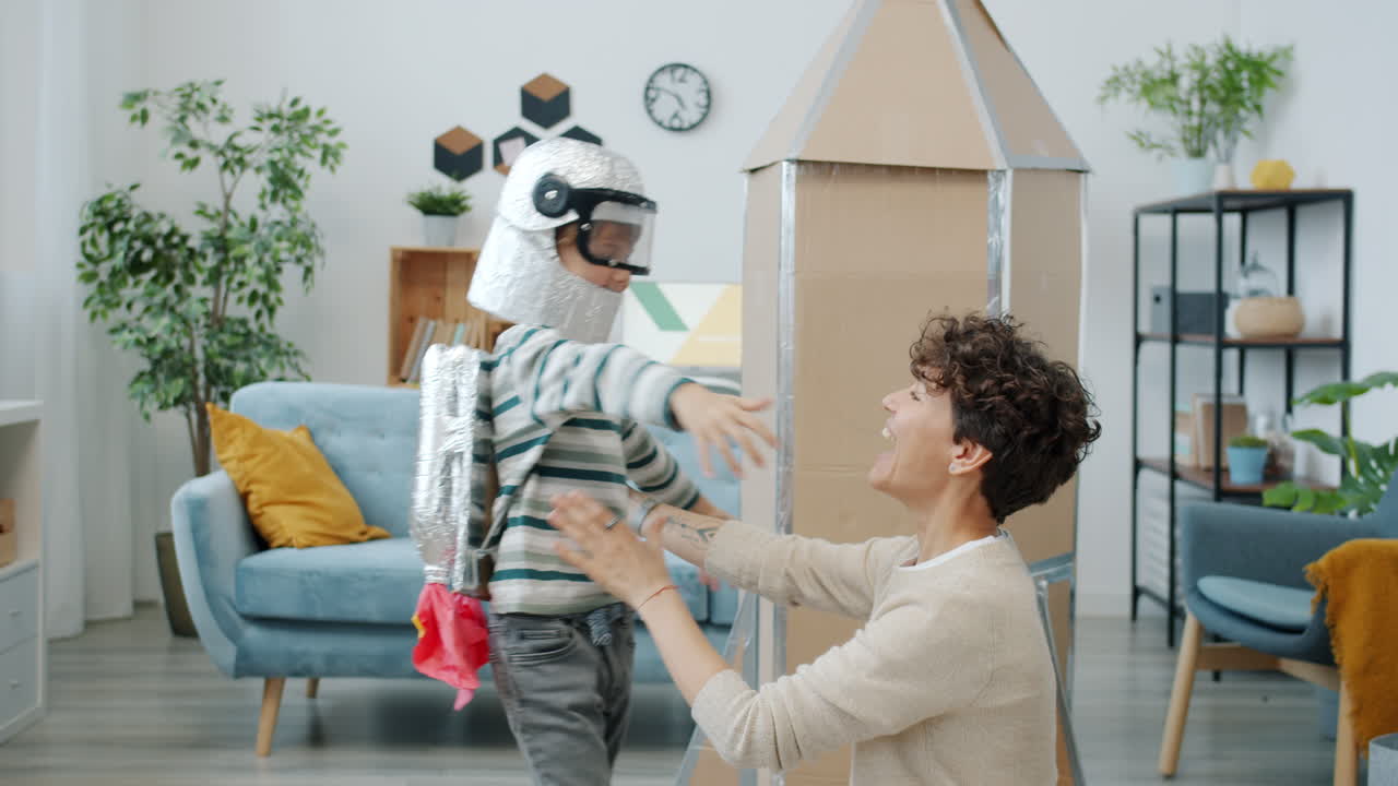 Child playing astronaut with mom