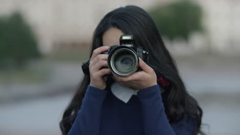 woman taking a picture with a camera