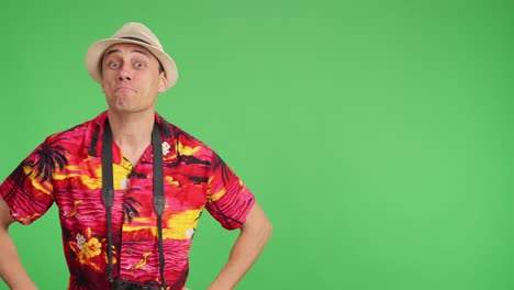 Tourist pointing and smiling on green screen background