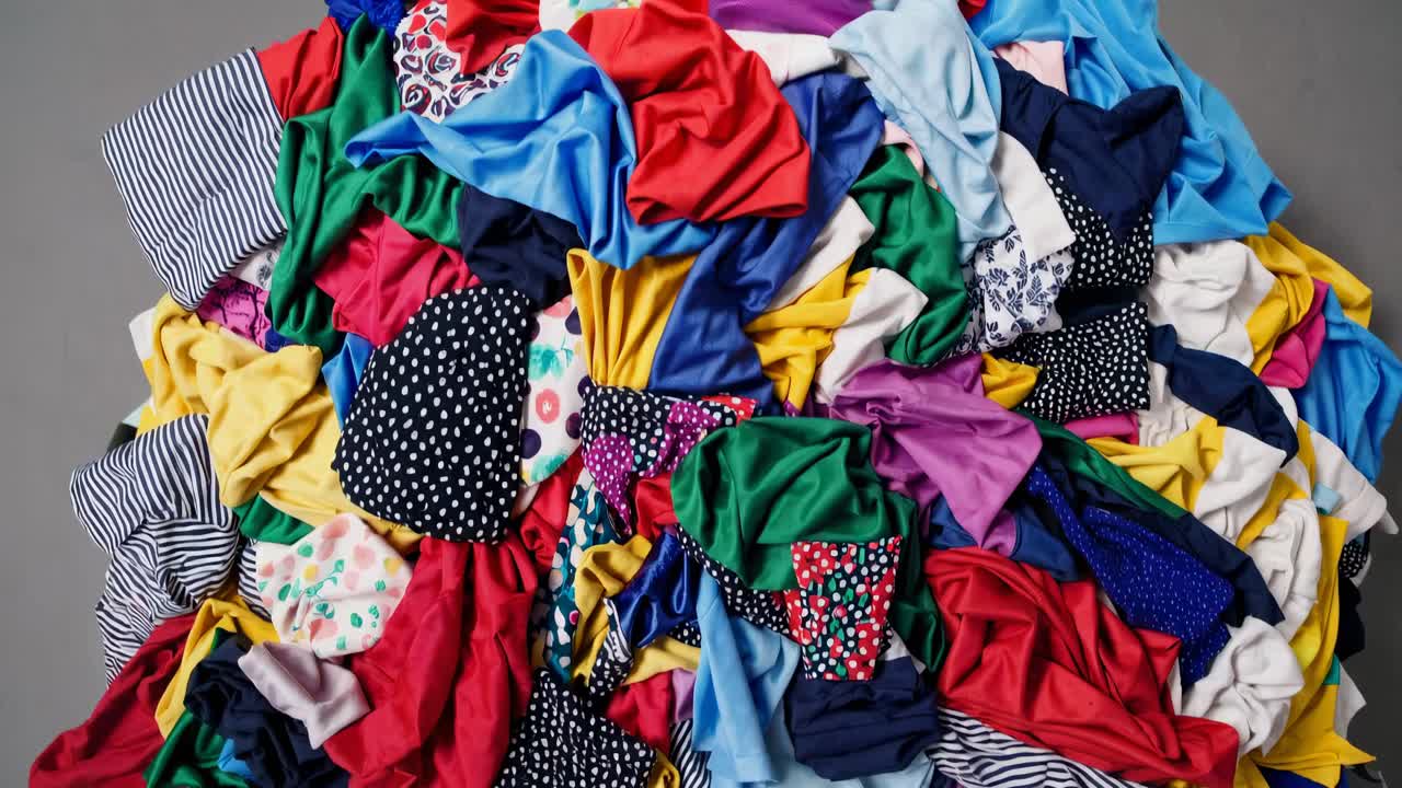 Aerial view of a colorful pile of assorted fabrics, showcasing a vibrant mix of patterns