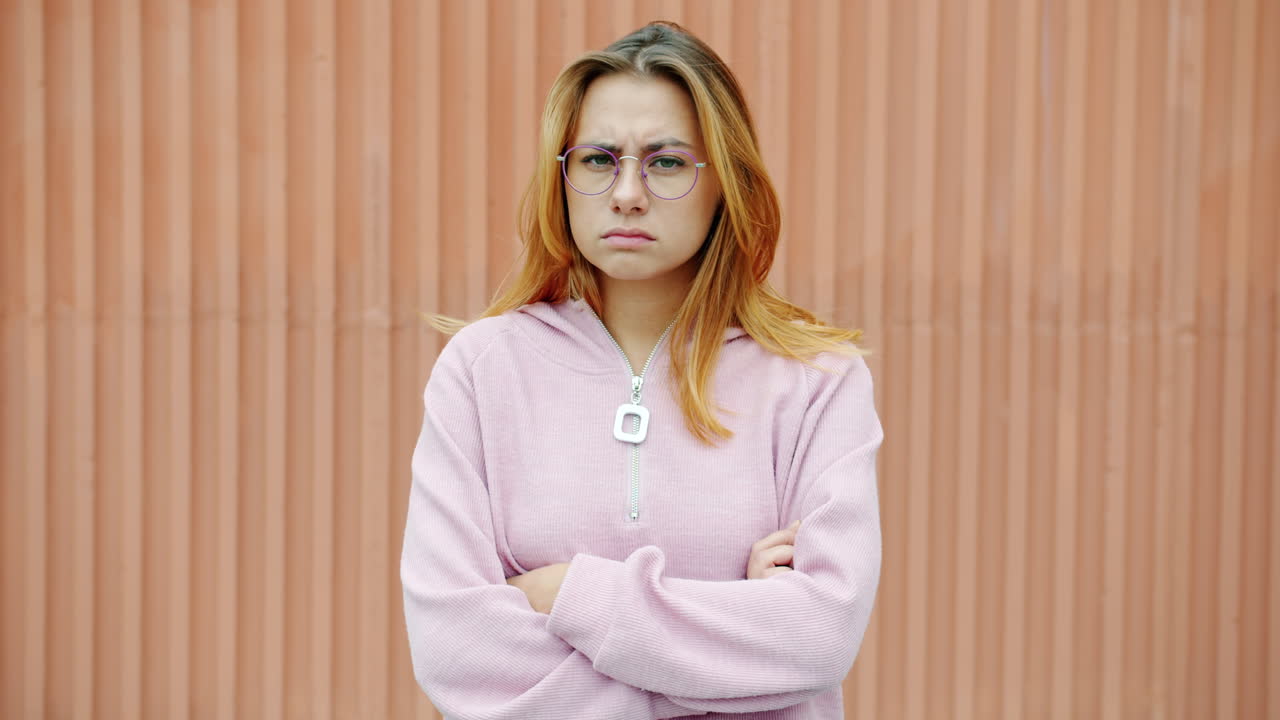 Angry Young Woman in Pink Sweatshirt