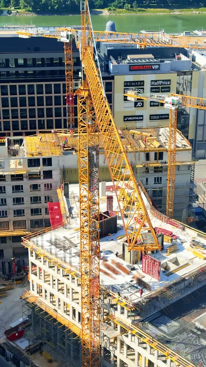 Urban construction with crane. A large construction site is bustling with activity as workers and cranes assemble a new building in the city