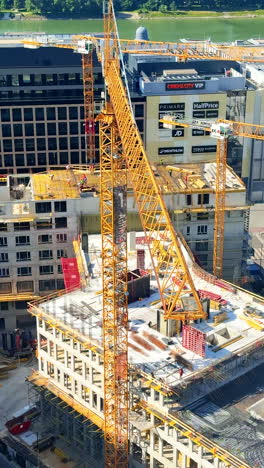 urban construction with crane. a large construction site is bustling with activity as workers and cranes assemble a new building in the city