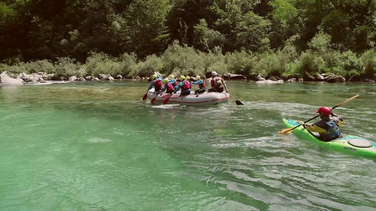 vista aérea de un grupo remando en un bote de rafting en el río soca, eslovenia.