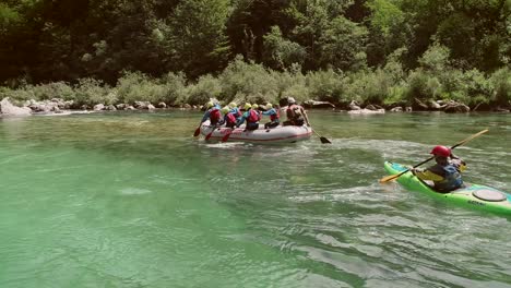 aerial view of a group paddling in a rafting boat at the soca river, slovenia.