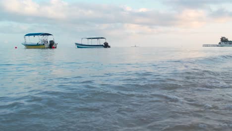 Static-footage-of-Boats-on-the-waves-in-turquoise-seawater-on-Caribbean-coast