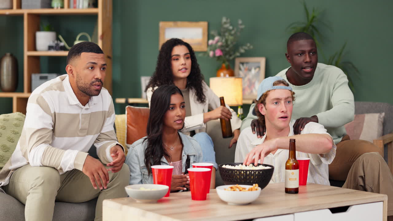 Friends watching tv, drinking beer and eating popcorn