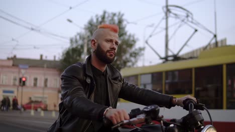 handsome rider man sitting on classic motorbike on city street. brutal fun urban lifestyle