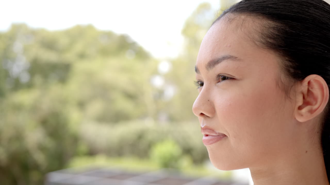 Looking into distance, smiling woman enjoying peaceful outdoor moment, copy space