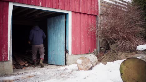 a man is moving the large logs to the storage area - static shot