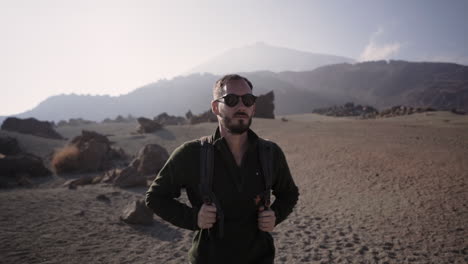 hot handsome hispanic backpacker strolling at desert area of tenerife teide spain