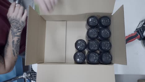 packaging canned drinks in a cardboard box