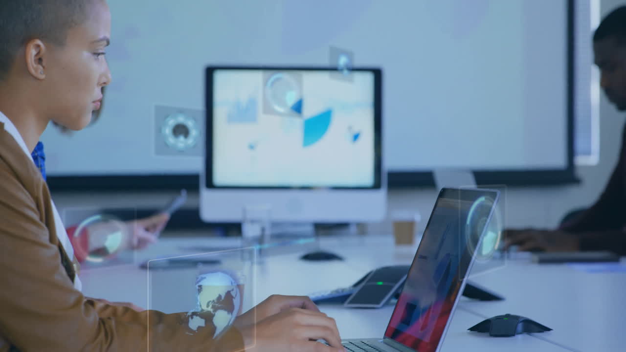 Two professionals typing on laptops in business meeting UI overlays, charts floating above table