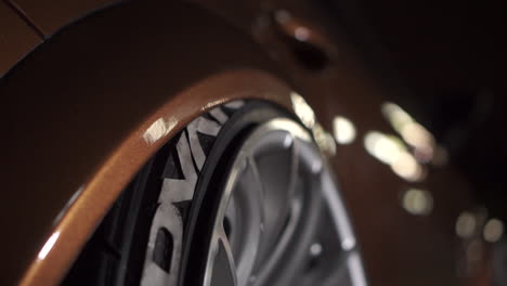 close-up of a car wheel and tire at night