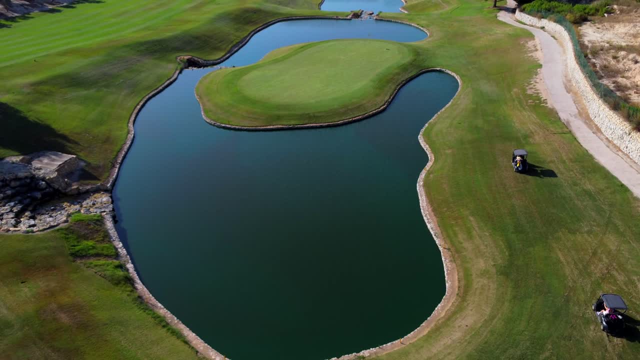 Aerial View of a Golf Course with Pond and Golf Carts