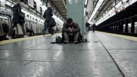 homeless man in a subway station