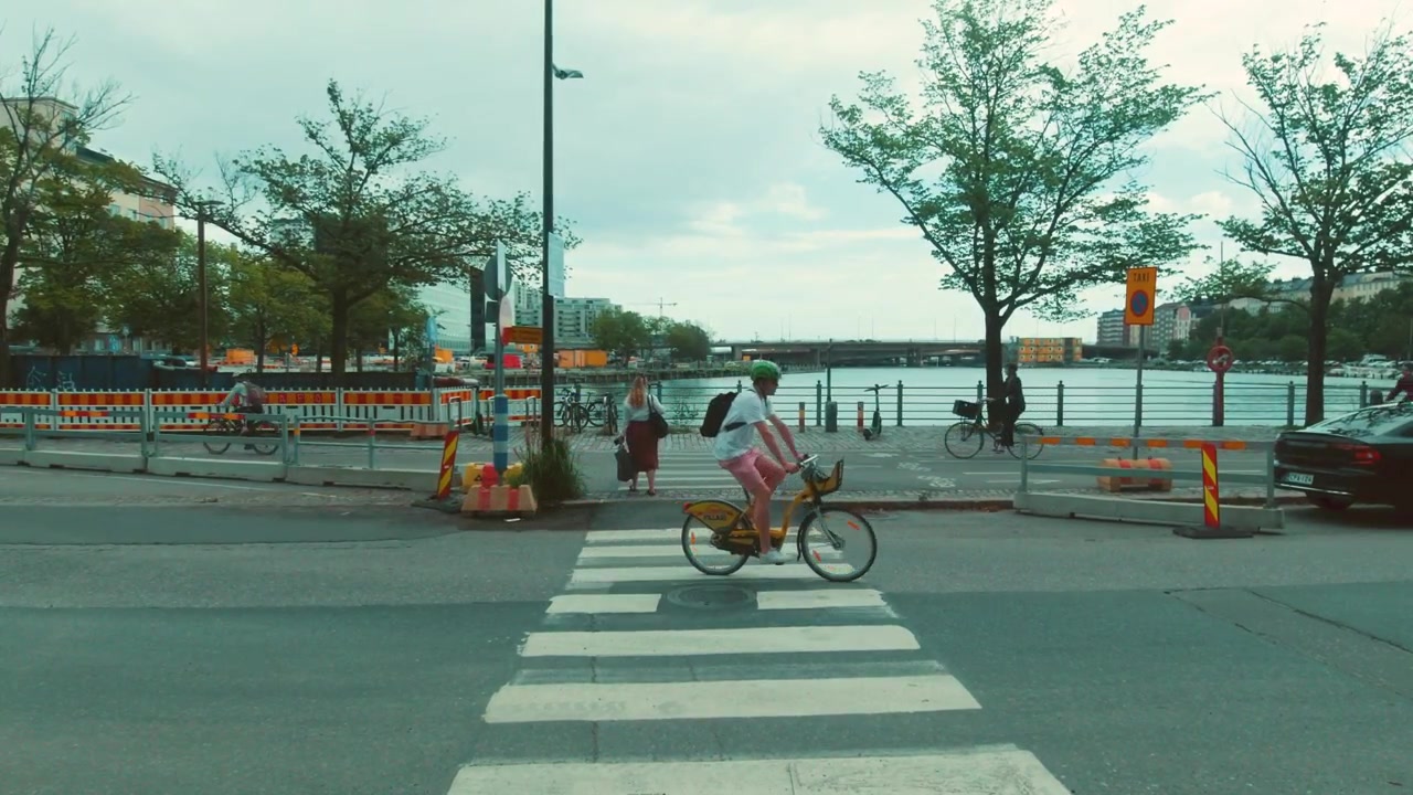 Zebra Crossing in Helsinki with People Crossing Over the Road and Cyclists Commuting Near the Harbour, Finland.