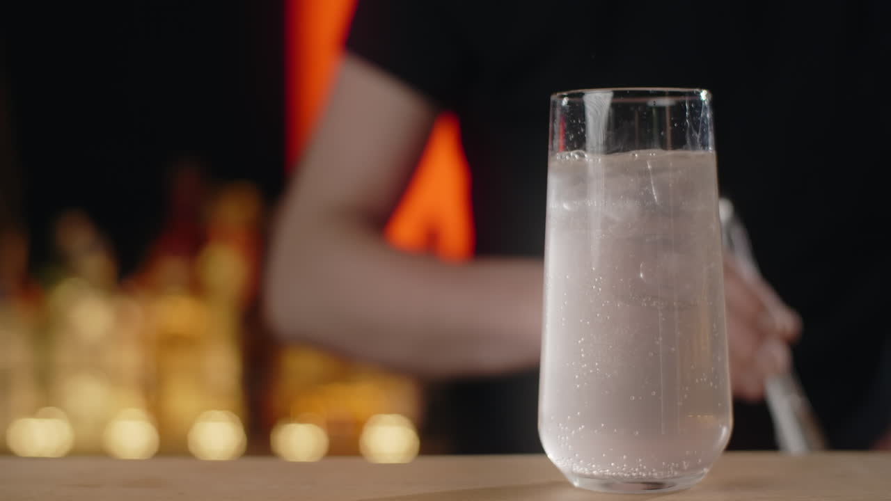 Bartender preparing a drink at a bar