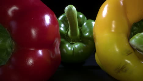 red, green and yellow bell peppers outwards macro shot