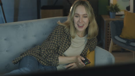 woman watching tv on couch
