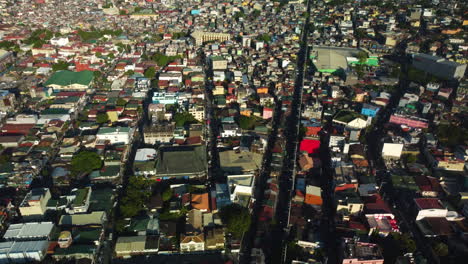 Aerial-view-tilting-over-the-cityscape-of-Makati-city,-in-sunny-Philippines