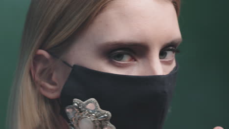 close up of beautiful woman in face mask with jewelry