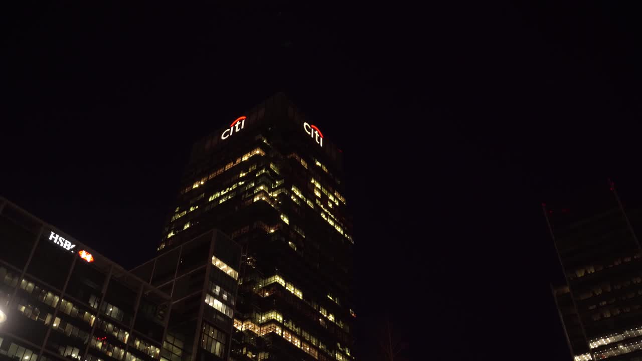 Buildings at night in Canary Wharf, London, England, low angle wide shot