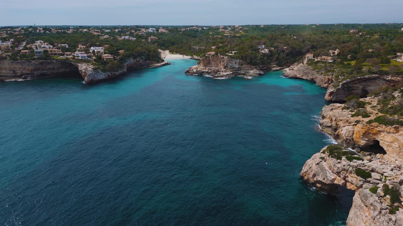 Baia remota di Es Pontas, acqua di mare cristallina blu turchese con spiaggia di sabbia bianca, villa di lusso