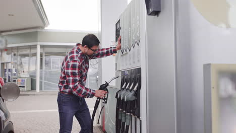 man filling gas at a gas station