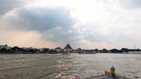 a tranquil scene of the chao phraya river in bangkok, thailand, with boats and traditional architecture under soft, diffused sunlight