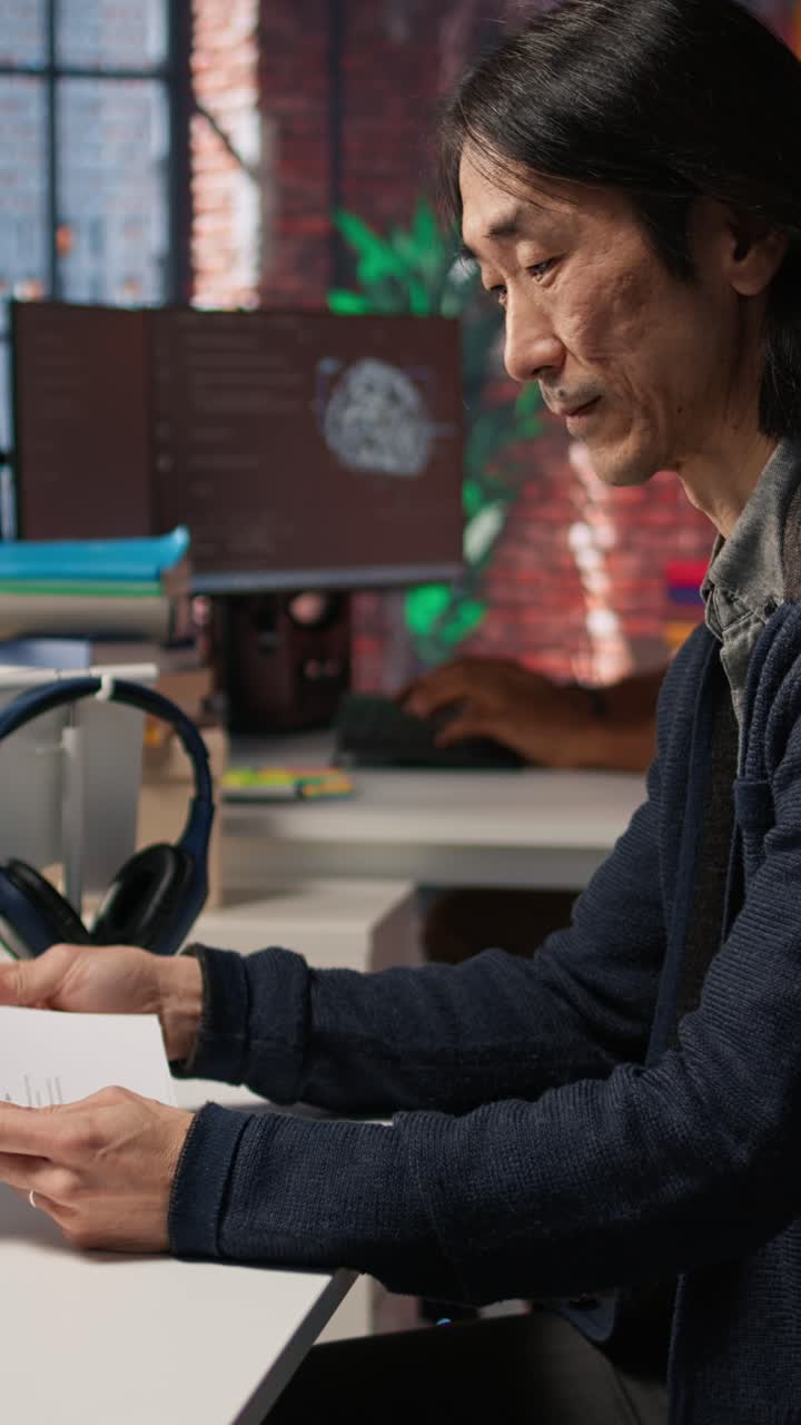 Vertical video Senior tech startup HR recruiter identifying candidates for job, reviewing CVs