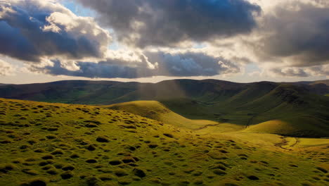 rolling green hills under a dramatic sky with sun rays