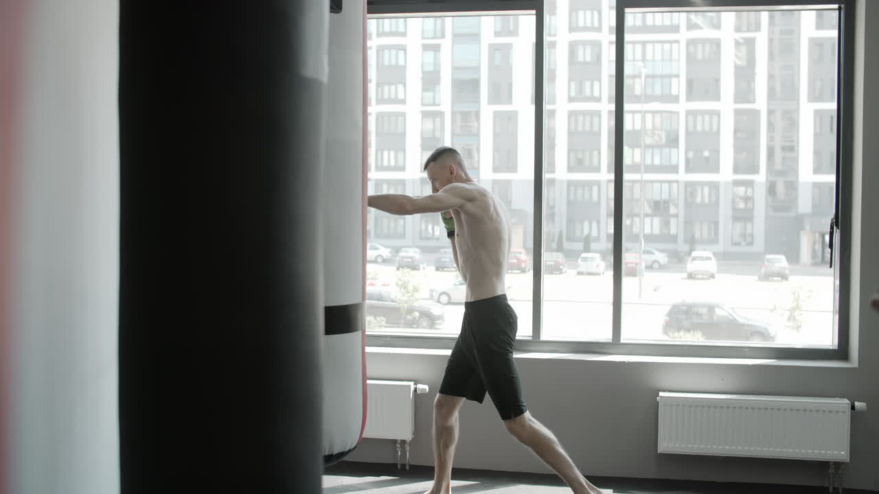 Men practicing kickboxing in gym