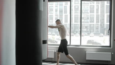 men practicing kickboxing in gym
