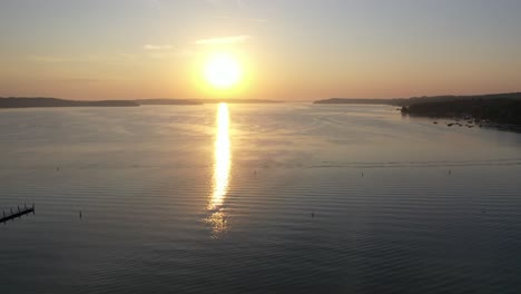 aerial-shot-of-lake-geneva,-Wisconsin-during-golden-hour-over-a-marina