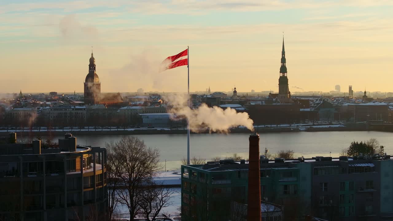 Establishing view of Riga in winter sunrise, national flag waving in breeze