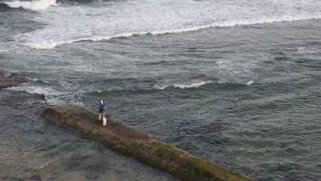 man rock fishing at bar beach-merewether beach, nsw, australia