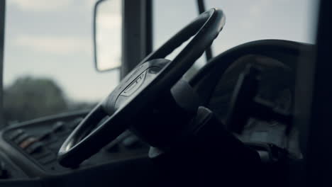 School-bus-black-helm-without-chauffeur-close-up.-Handlebar-on-schoolbus-cabin.