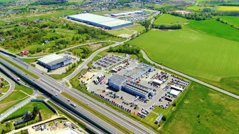 aerial view of warehouse storages or industrial factory or logistics center from above. top view of industrial buildings and trucks